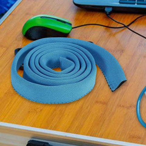 Blue insulated water bladder tube cover on a wooden table with green mouse; keeps hydration cold or hot, 92cm length.