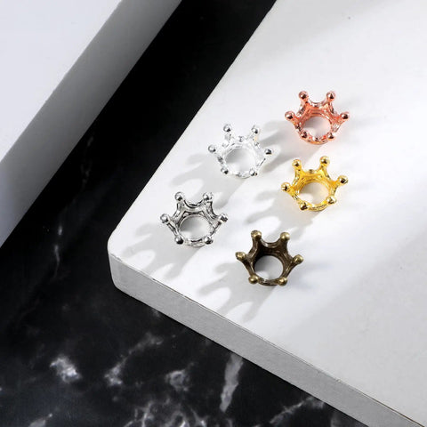 60 Piece Crown Charms Set For Jewelry Making With Six Vintage Colors 3D Alloy Crown Beads displayed on white and black surface