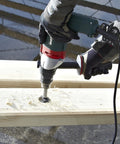 Heavy Duty One Half Inch High Torque Drill With Solid Six Point Seven Amp Motor drilling into wood surface with shavings flying.
