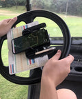 Rock Solid Golf Cart Phone Holder Steering Wheel Mount Spring Loaded Grip Holds phone on steering wheel while tracking score.