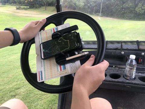 Rock Solid Golf Cart Phone Holder Steering Wheel Mount Spring Loaded Grip Holds phone on steering wheel while tracking score.