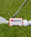 Portable Golf Launch Monitor Mevo with 3D Doppler Radar on grass with golf club and balls