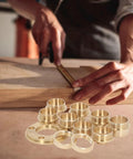 Boss Brass Router Template Guide Bushing Kit, eight brass sizes from 10 to 30mm, shown in use for precise routing control.