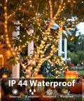 Lit 75.8 Ft 200 LED Christmas String Lights For Indoor And Outdoor Use With Timer And Memory Function on a tree, waterproof in rain.