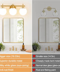 Next Level Three Light Bathroom Vanity Lights In Brushed Gold Finish With Milky White Glass Globe Shades Modern Wall Sconce Over Mirror above a stylish mirror.