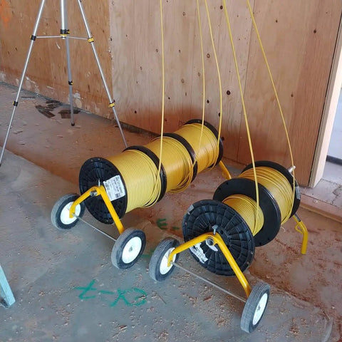 Mobile Wire Reel Rack With Wheels For 18 Inch Diameter Reels Up To 150 Lbs on construction site.