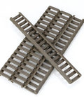 4 Pack Rifle Picatinny Rail Covers Rubber Tan And Black, laid out in a cross pattern, highlighting heat-resistant material.