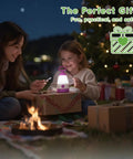 Child with Kid Friendly Camping Lantern And Night Light With AAA Batteries Included enjoying outdoor setting under a Christmas tree.