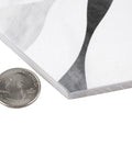Close-up of Dope Bardiglio Hex Flower Porcelain Tile 7x8 for Floor and Wall, showing thickness and glazed textured finish with a quarter for scale.
