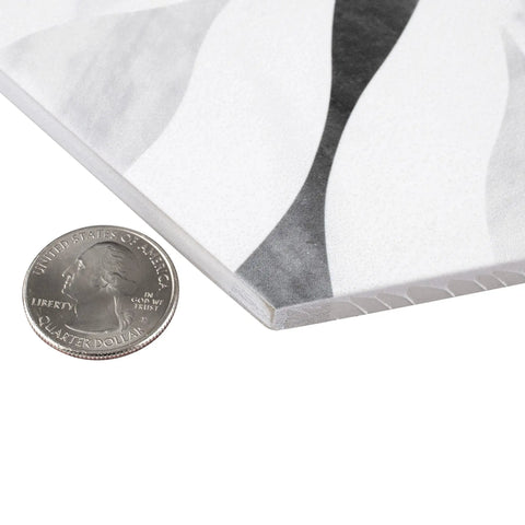 Close-up of Dope Bardiglio Hex Flower Porcelain Tile 7x8 for Floor and Wall, showing thickness and glazed textured finish with a quarter for scale.