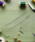 Five Piece Metal Drawstring Threader Tool Set For Sewing, Handy On The Go Design, Portable Quick Insert Threading Tool For Cords And Pants, Ideal For Sweatpants And Hoodies, Easy Threading Every Time on green fabric with two metal threaders