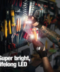 Person wearing LED Flashlight Gloves For Men Dads From Daughter Son Wife Hands Free Light For Fishing Camping Auto Repair And DIY Projects A Handy As Heck Gift For Him Who Has Everything in a tool workshop