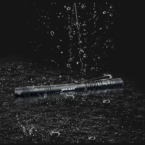 2-Pack Mini UV Black Light Flashlights 395nm for Leak Detection under waterproof test in rain, durable pocket tool.