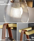 Fluted Glass Wall Sconce Ribbed Shade Leather Strap Brass Finish Metal Light 10 Inch Height features glass lampshade, leather, and metal body.