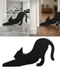 Black Eco Friendly Door Stopper With Soft Impact Absorbing Block shaped like a cat, used to hold a door open on hardwood floor.