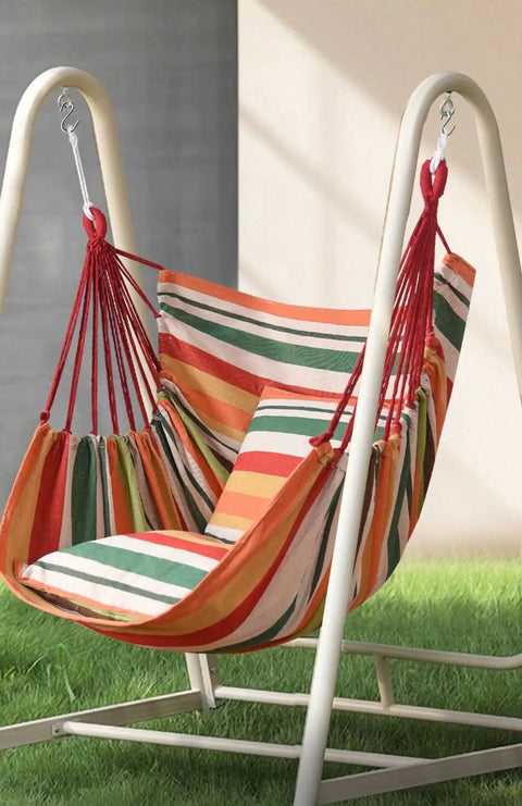 Striped hammock chair on a stand, colorful canvas fabric, suitable for indoor and outdoor use, sturdy frame supports relaxation.