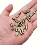 Solid Bronze Shelf Pins 100 Pack Cabinet Pegs For Straight Up Diy Fixes shown in hand, showcasing smooth zinc alloy spoon shapes.