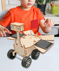 Child assembling Solar Powered Mars Rover Kit Made Of Wood For DIY Engineers A Dope Educational STEM Project That Teaches Solar Energy