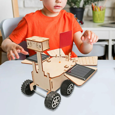 Child assembling Solar Powered Mars Rover Kit Made Of Wood For DIY Engineers A Dope Educational STEM Project That Teaches Solar Energy
