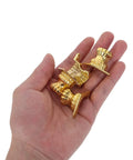 Hand holding antique metal box feet corner protectors set of 20 for jewelry boxes and wood cases, old school retro style.