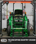 Telescoping Gantry Crane Frame Only For 2 Ton Loads lifting green tractor with locking wheels in shop