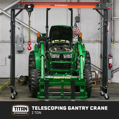 Telescoping Gantry Crane Frame Only For 2 Ton Loads lifting green tractor with locking wheels in shop
