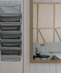 Straight Up Game Changer Over The Door Shoe Rack With Six Roomy Pockets hanging on door with modern decor and couch in background.