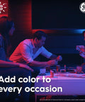 Three people enjoying a game under Color Changing A19 Smart LED Light Bulbs With Bluetooth And WiFi, 60W Equivalent lighting.
