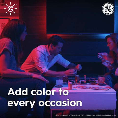 Three people enjoying a game under Color Changing A19 Smart LED Light Bulbs With Bluetooth And WiFi, 60W Equivalent lighting.