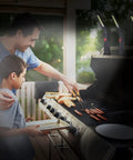 Father and son grilling with Eight Piece LED Work Light Set With Magnetic Base And Hanging Hook on outdoor kitchen counter