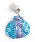 Close-up of a metal butterfly-shaped tablecloth weight with clip, part of the Eight Pack Colorful Butterfly Tablecloth Weights With Clips For Outdoor Parties Picnics And Backyard Dinners Durable Metal Clip Weights That Grip Tight And Stay Put Rust Resistant And Easy To Use.