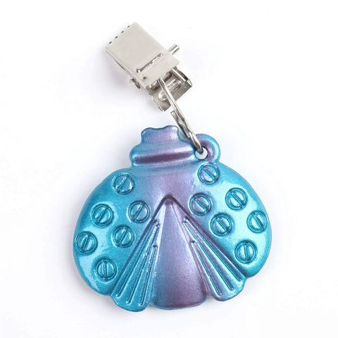 Close-up of a metal butterfly-shaped tablecloth weight with clip, part of the Eight Pack Colorful Butterfly Tablecloth Weights With Clips For Outdoor Parties Picnics And Backyard Dinners Durable Metal Clip Weights That Grip Tight And Stay Put Rust Resistant And Easy To Use.