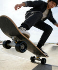 Skater in action using 60mm 88A skateboard wheels with bearings set of 4 black for street and park skating, cruising carving and tricks.
