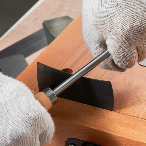 Close-up of hands using the sharpener on the Top Shelf Six Piece Cabinet Scraper And Burnisher Kit With Blue Spring Steel Blades Plus Hardened High Speed Steel Sharpening Rod For Knockout Woodworking Finishes Daily.