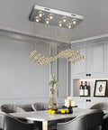 Modern K9 Crystal Chandelier Light Fixture With 8 Lights Raindrop Chandeliers In An S Shaped Flush Mount Ceiling Light That Makes Your Kitchen Island Bedroom And Dining Room Pop, hanging over a dining table in a modern interior setting.