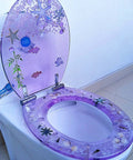 Vibrant Purple Round Resin Toilet Seat With Embedded Sea Shells, Hella Smooth Slow Close Metal Hinge, Tough Four Hundred Pound Capacity with a coastal design.