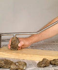 Person using Premium Stainless Steel Oyster Opener With Knife On Wooden Base For Easy Shucking And Quick Oyster Opening