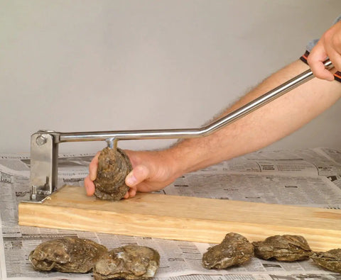 Person using Premium Stainless Steel Oyster Opener With Knife On Wooden Base For Easy Shucking And Quick Oyster Opening