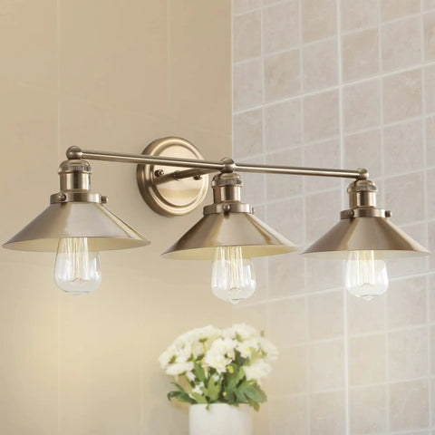 Brass Gold 3 Light Industrial Farmhouse Vanity Wall Sconce With Metal Shade in bathroom setting, LED bulbs illuminated