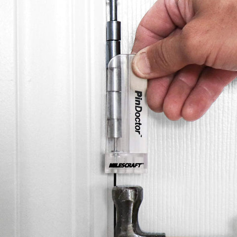 Hand using Milescraft Pin Doctor tool on door hinge alignment visible, part of Dual Clamping Door Hinge Jig Plus Hinge Mortiser For Standard Doors Easy Setup Complete Installation Kit To Rout Mortises From 2.5 To 4.5 Inches Includes Strike And Latch Plates Padded Self Clamping Design Adjustable For One And Three Eighths Inch And.