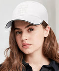 Woman wearing a Vintage White Adjustable Cap For Women And Men, Modern Statement Hat With Soft Feel, Comfortable All Day Wear