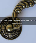 Close-up of Six Pack Vintage Drop Bail Cabinet Handles In Antique Brass Finish, featuring premium zinc alloy construction.