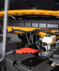 Ford Bronco 2.3L engine with installed catch can, showing aluminum 6061 construction and OEM style quick disconnect fittings.