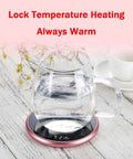 Electric Mug Warmer With Adjustable Temperature And Smart Touch Control, Auto Shut Off Timer Keeps That Morning Brew Piping Hot, Premium Silver Aluminum Alloy Desk Cup Heater For Work Or Chill with a glass kettle on a warming pad.