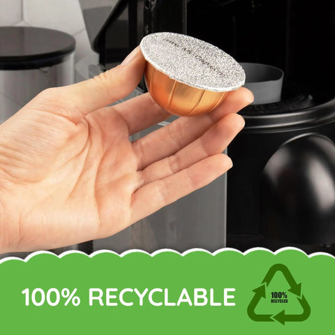 Foil Seals For Nespresso Vertuo Pods Reusable Aluminum Lids To Extend The Life Of VertuoLine Capsules Pack Of 100 Silver Keeps Coffee Fresh Leak Resistant Easy To Reuse High Quality Kitchen Essential displayed in hand with recycling symbol