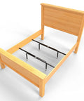 Heavy Duty Bed Slats Center Support System with adjustable legs for queen and king beds in a wooden frame.