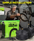 Two Pack 26x1.75-2.125 Butyl Bike Tubes With 35mm Schrader Valve Built For MTB Cruisers City And Road Bikes Includes Two Tire Levers Ready To Roll Spare Set For 26 Inch Tires package, tubes, and tire levers displayed in front of bike being repaired.