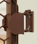 Close-up of brown hinge for 192-Inch Ultra Wide 2-In-1 Baby Gate And Play Yard With Door, Adjustable 6-Panel Plastic Safety Gate