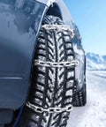 Car tire with zinc-plated chains in snow, showcasing Grade 30 Chain Quarter Inch By 100 Feet Zinc Plated Proof Coil Chain.