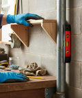 Spirit Level, 3, New Yellow Level 23CM used to level a wooden shelf during installation, with blue gloved hand.